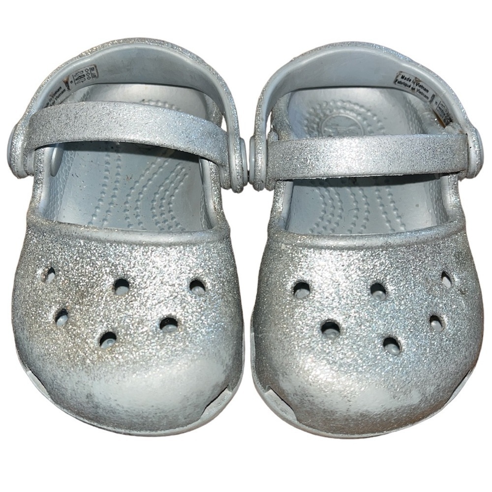 Baby’s silver glitter Crocs. 
Baby’s size 4